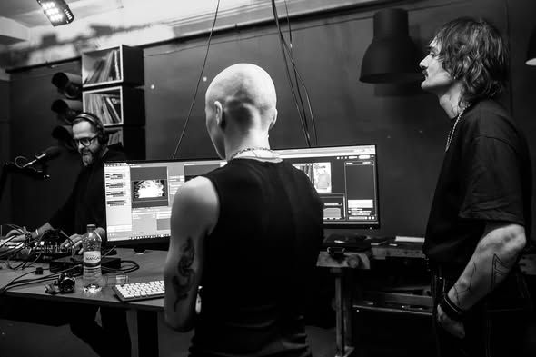 The host desk with monitors and studio guests