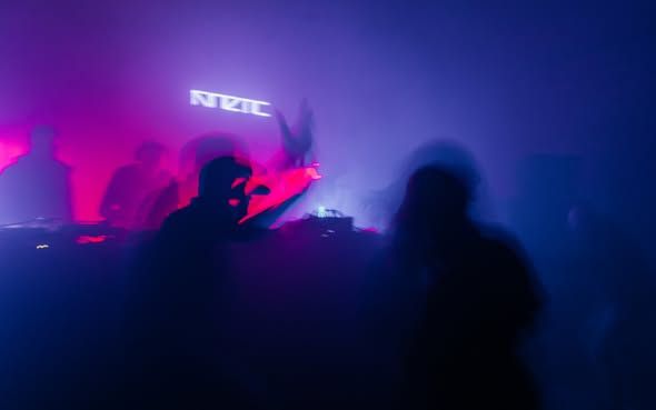 Dancers in magenta and blue light